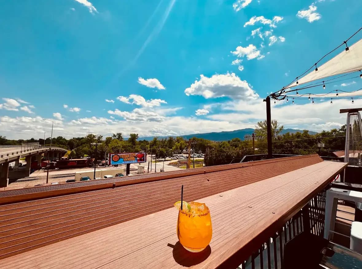 Cocktail on the rooftop railing with Canon City views