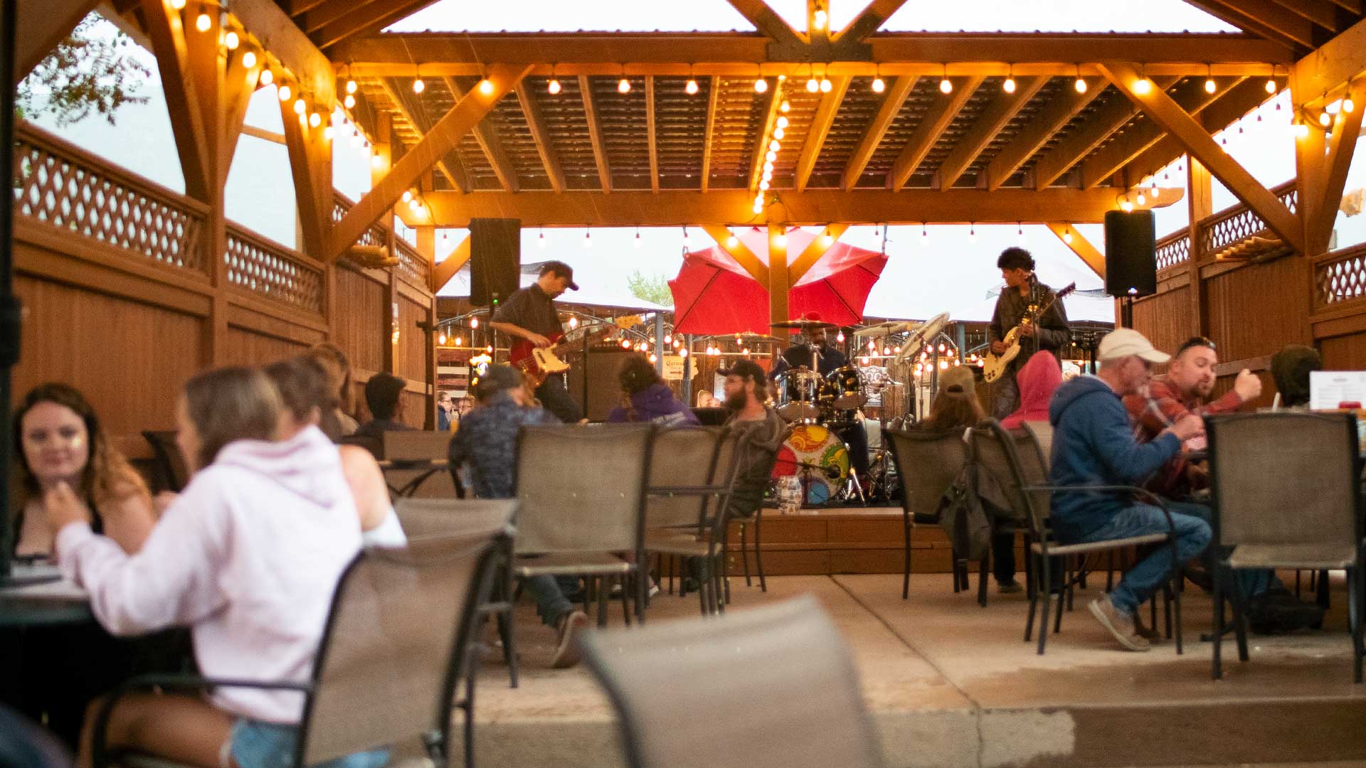 Live music at Whitewater Bar & Grill with string lights and timber pavilion