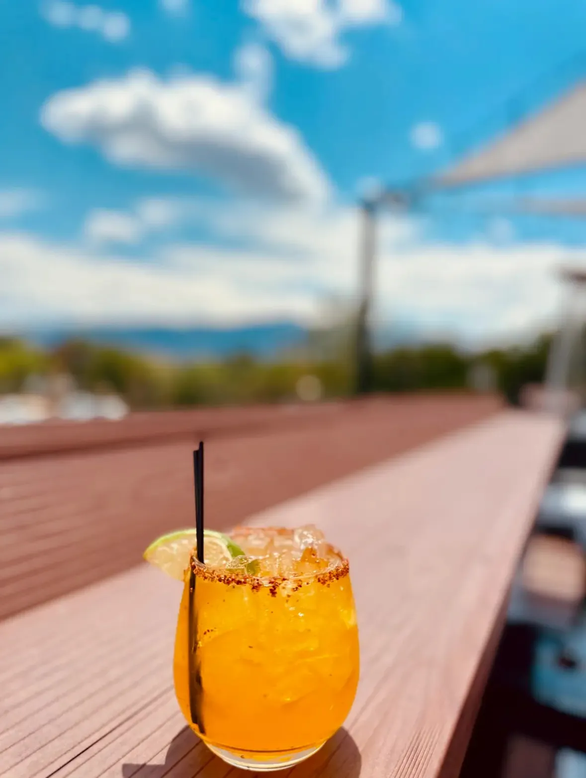 Craft cocktail with mountain views at Rooftop Social